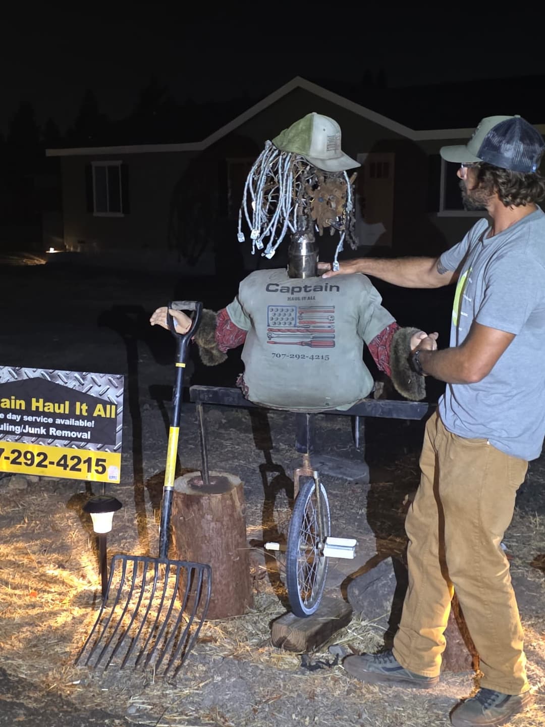 Custom scarecrow display built from reclaimed materials for outdoor property feature.