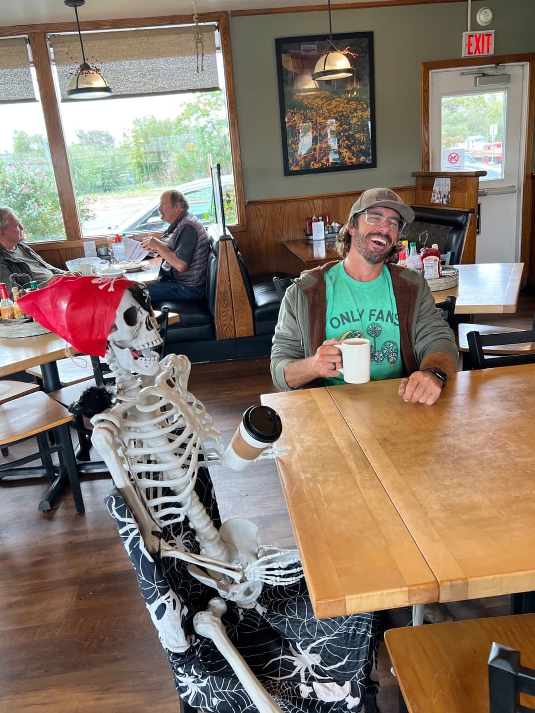 Indoor restaurant seating featuring custom skeleton display and themed decor.