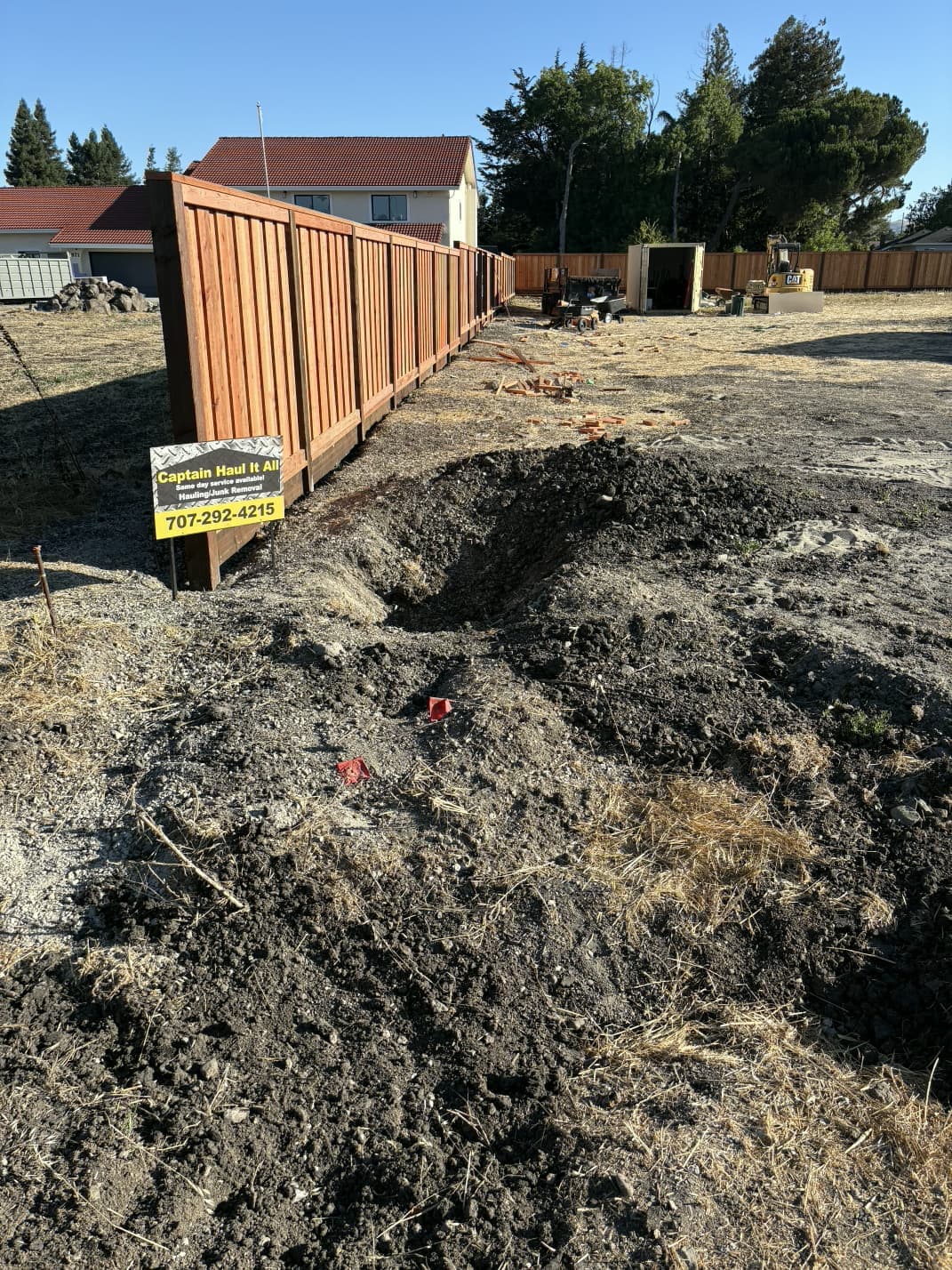 Cleared dirt area after debris removal and ground cleanup.